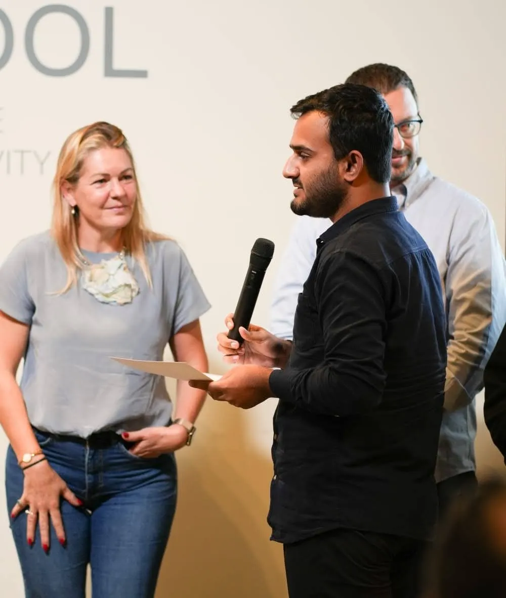 Speaking into a microphone during a Pi School session
